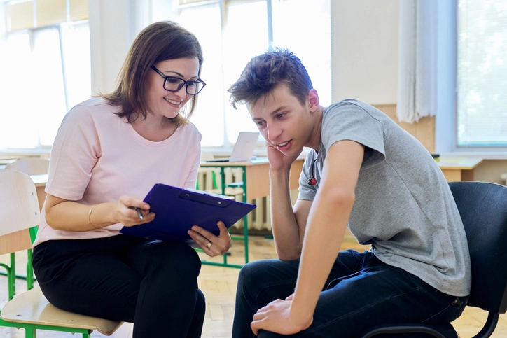 An instructor at a therapeutic boarding school works one-on-one with a student